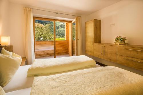 a bedroom with two beds and a window at Chalet S Apartments in Campo Tures