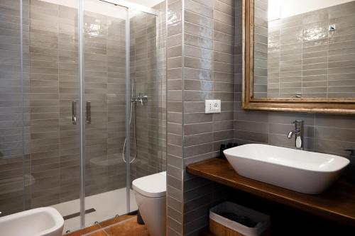 a bathroom with a shower and a sink and a toilet at Vicolo Effe in Terracina