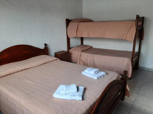 En eller flere senge i et værelse på Departamentos Stella