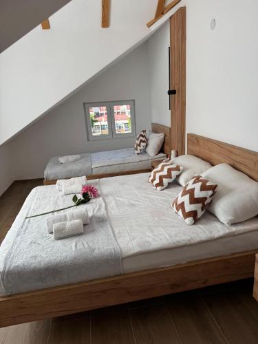 a bedroom with two beds with pillows on them at Viktor Lux Apartmani in Soko Banja