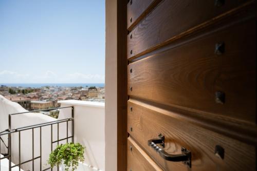 a door to a balcony with a view of a city at Vicolo Effe in Terracina
