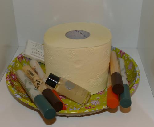 a cake with a roll of toilet paper on a plate at City Apartmentstudio mit Tiefgarage free parking in Graz