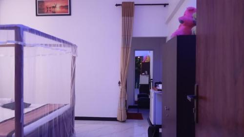 a bedroom with a bunk bed with a teddy bear on the wall at Green Ocean Bay in Arugam Bay