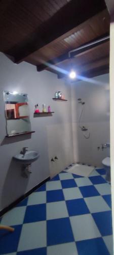 a bathroom with a sink and a tiled floor at Bird Guesthouse in Taghazout