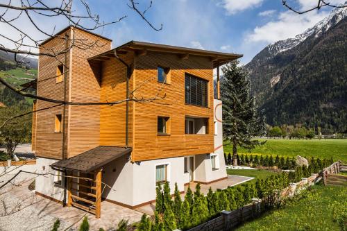 a house in the mountains with a tower at Chalet S Apartments in Campo Tures