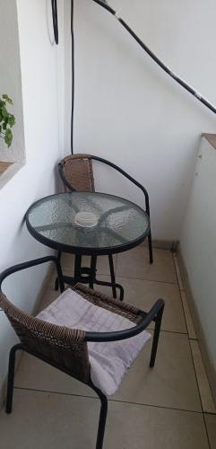 a glass table and a chair in a room at Apartament Alexandra in Orşova
