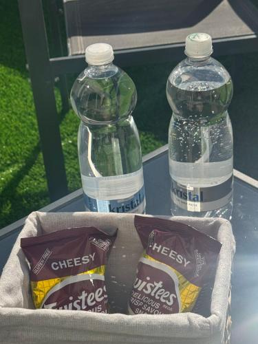 two bottles of water sitting on top of a table at The Fifth Penthouse - 3 Large Bedrooms in Il-Gżira