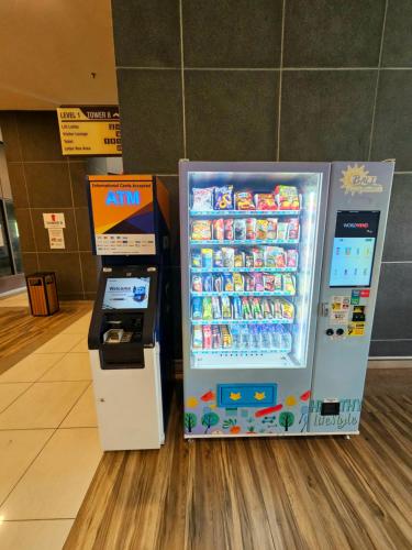 a drink cooler and a soda machine in a store at Atlantis Residence Melaka By GGM in Melaka