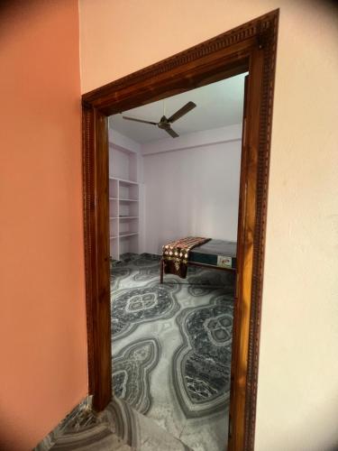 a mirror reflection of a room with a table at Tej Home Stays and Guest House in Miriālgūda