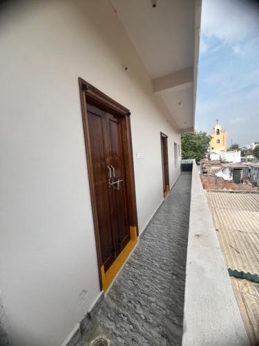 a corridor of a building with a door on the side at Tej Home Stays and Guest House in Miriālgūda