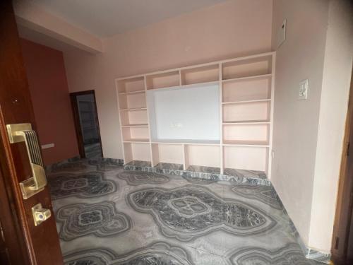 a room with a mosaic tile floor with a window at Tej Home Stays and Guest House in Miriālgūda