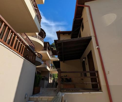 an alley between two buildings with balconies at Althea Apartments in Katakolon