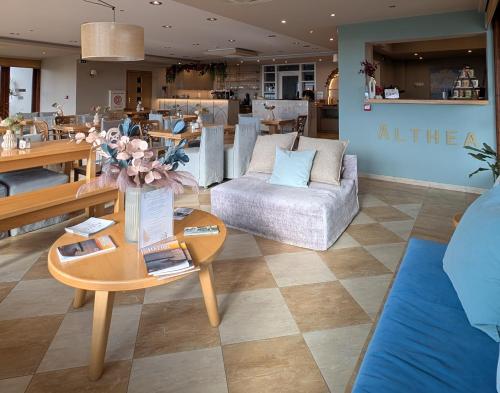a living room with a couch and a table at Althea Apartments in Katakolon