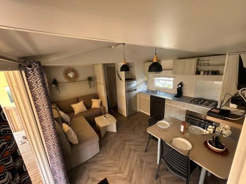 a small living room with a couch and a table at La Palmyre - Les Mathes - Nouveau Mobil home - Camping 4 étoiles "Les Charmettes" in Les Mathes