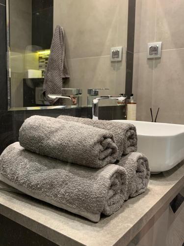 a pile of towels sitting on a counter in a bathroom at Rajska 3 in Kraków