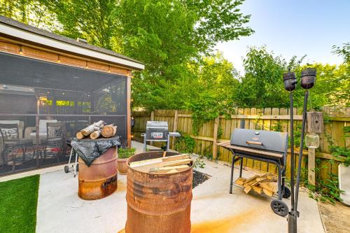 a patio with a grill and a table and a grill at Home with Hot Tub, Playset and Grills in Clarksville! in Clarksville