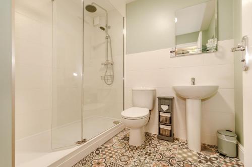 a bathroom with a shower and a toilet and a sink at Rails End in Whitby