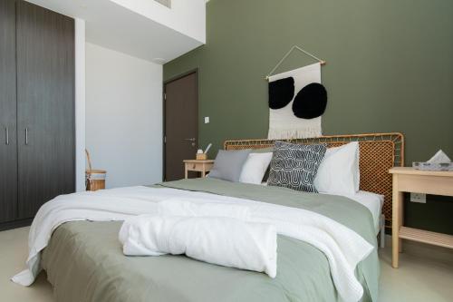 a bedroom with a large bed with white sheets and pillows at Elite Escape Holiday Home - 2 BHK Getaway with Dubai Mall Access - 1508 in Dubai