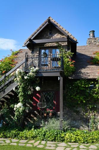 a house with a balcony and flowers on it at ONX WINES - Briarwood Apartment in Templeton