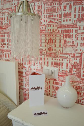 a white vase and a box on a table with a wall at Marcona24 in Milan