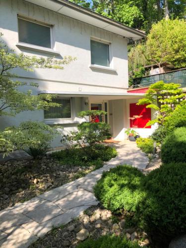a house with a walkway in front of it at Le Jardin De La Tuilerie Alsace in Pfastatt