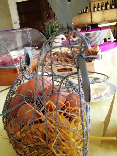 a basket full of donuts sitting on a table at Hotel Lux in Cesenatico
