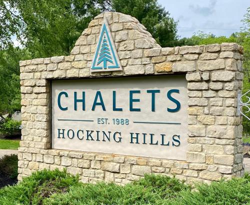 a sign for chateslocking hills in a stone wall at A-Frame #01 - by The Chalets in Logan