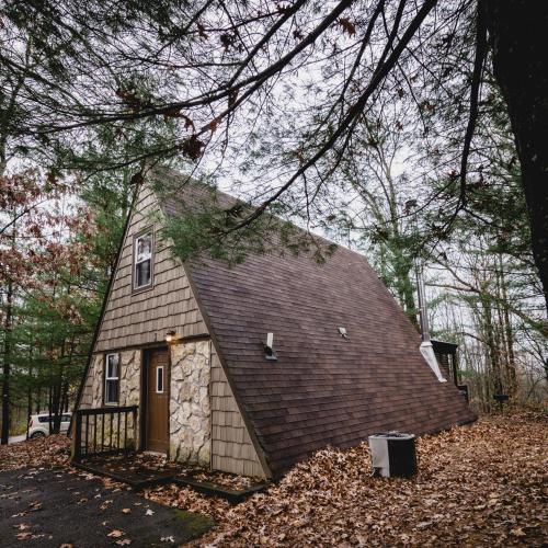 a small house with a gambrel roof at A-Frame #02 - by The Chalets in Logan