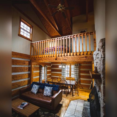 a living room with a couch and a table at Aspen - by The Chalets in Logan