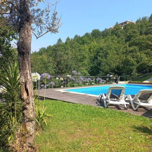 two lounge chairs next to a swimming pool at Villa Natura in Cova