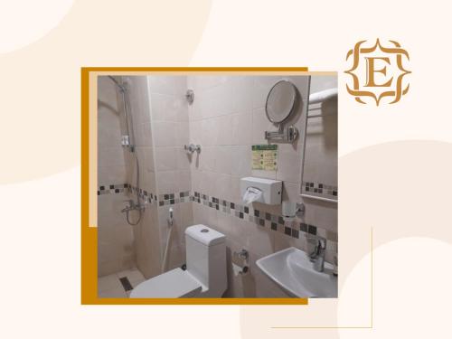 a bathroom with a toilet and a sink at فندق جولدن إيليت - Golden Elite Hotel in Al Khobar