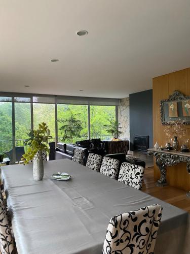 a living room with a large table and chairs at Villa Natura in Cova