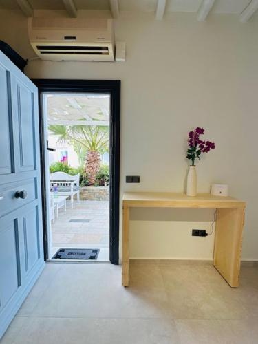a room with a desk and a door to a patio at Memories in Ornos