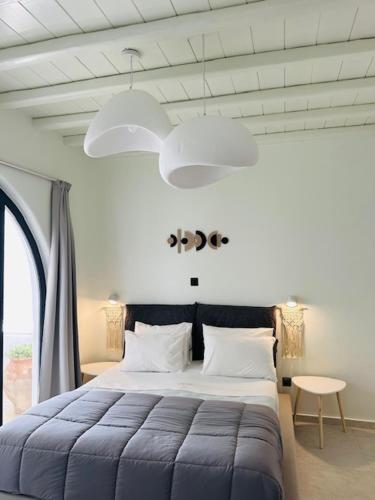 a bedroom with a large bed and a large window at Memories in Ornos