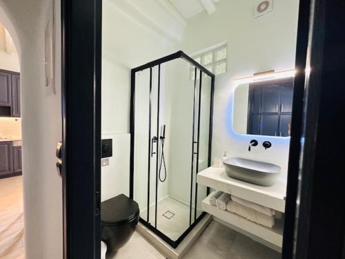 a bathroom with a sink and a glass shower at Memories in Ornos