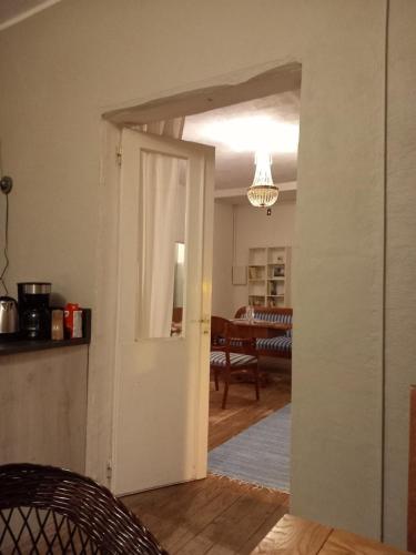 an open door into a living room with a dining room at Ferienhaus Loft in Küstennähe in Ruda