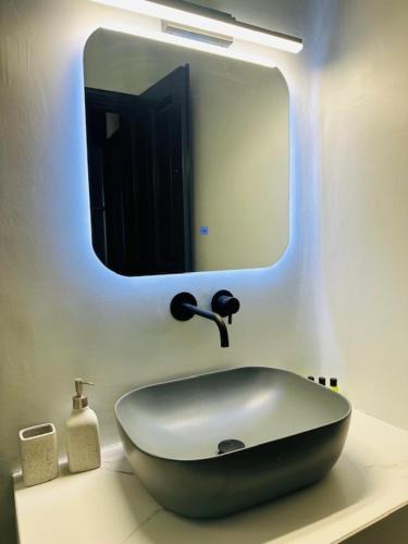 a bathroom with a sink and a mirror at Memories in Ornos