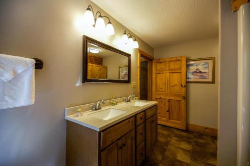 a bathroom with a sink and a mirror at Dogwood - by The Chalets in Logan