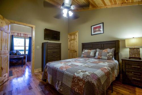 a bedroom with a bed and a dresser and a window at Overlook - by The Chalets in Logan