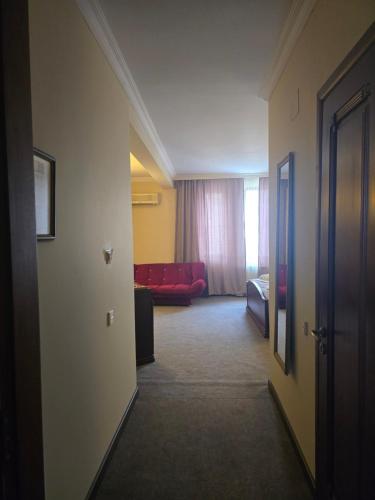 a hallway of a hotel room with a bed and a couch at Ritsa Boutique Hotel in Batumi
