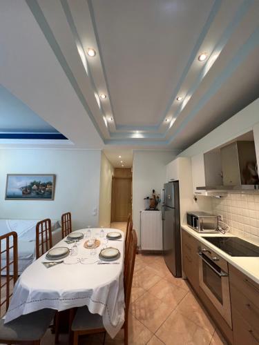 a kitchen with a table with a white table cloth at AurantiaSuites in Koroni