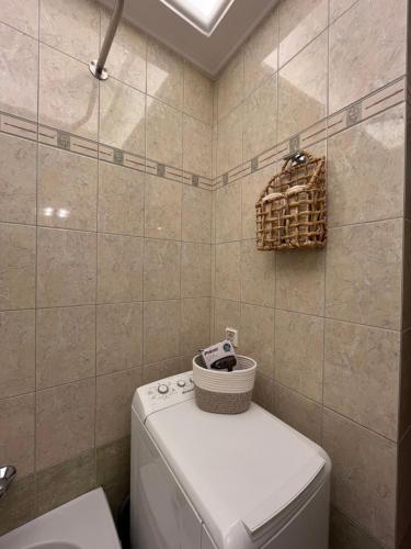 a small bathroom with a toilet and a sink at AurantiaSuites in Koroni