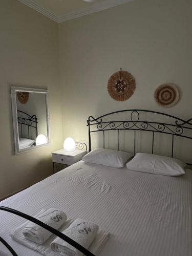 a bedroom with a bed with two towels on it at AurantiaSuites in Koroni