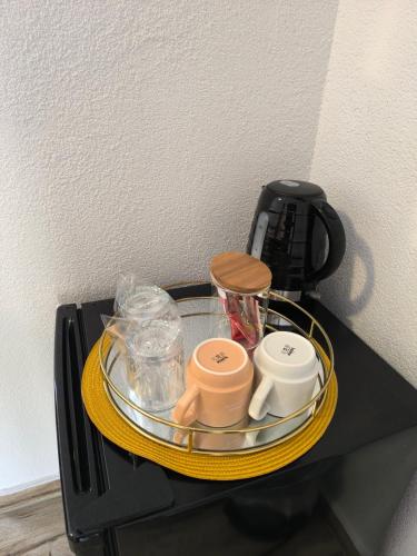 a tray with cups and other items on a table at House Mila in Korenica