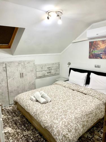 a bedroom with a bed with two towels on it at Coastal vista retreat in Neos Panteleimonas