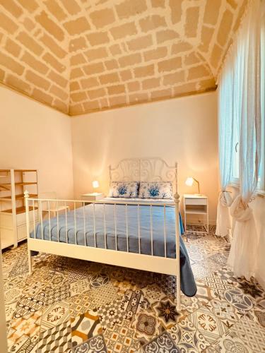 a bedroom with a bed and a brick ceiling at Favignana in centro con terrazza in Favignana