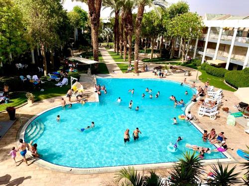 a group of people in a large swimming pool at רויאל פארק פרימיום in Eilat