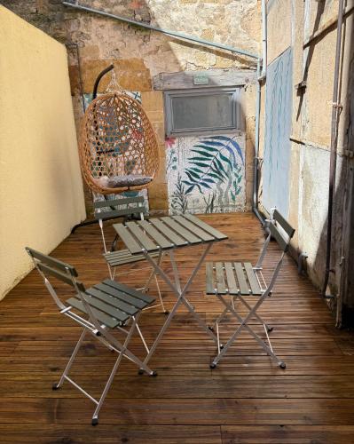 a couple of chairs and a table in a room at Le Renaissance Appartement au cœur de Langres in Langres