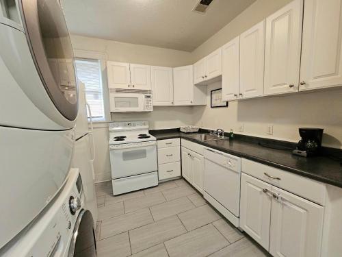 a white kitchen with white appliances and white cabinets at Cool and calm place to live in Memphis