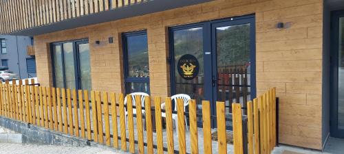 a wooden fence in front of a building at Mavrov02 Residence in Mavrovo